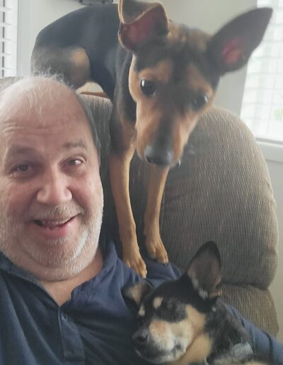 Amber and Chloe trying to share their daddy's lap.